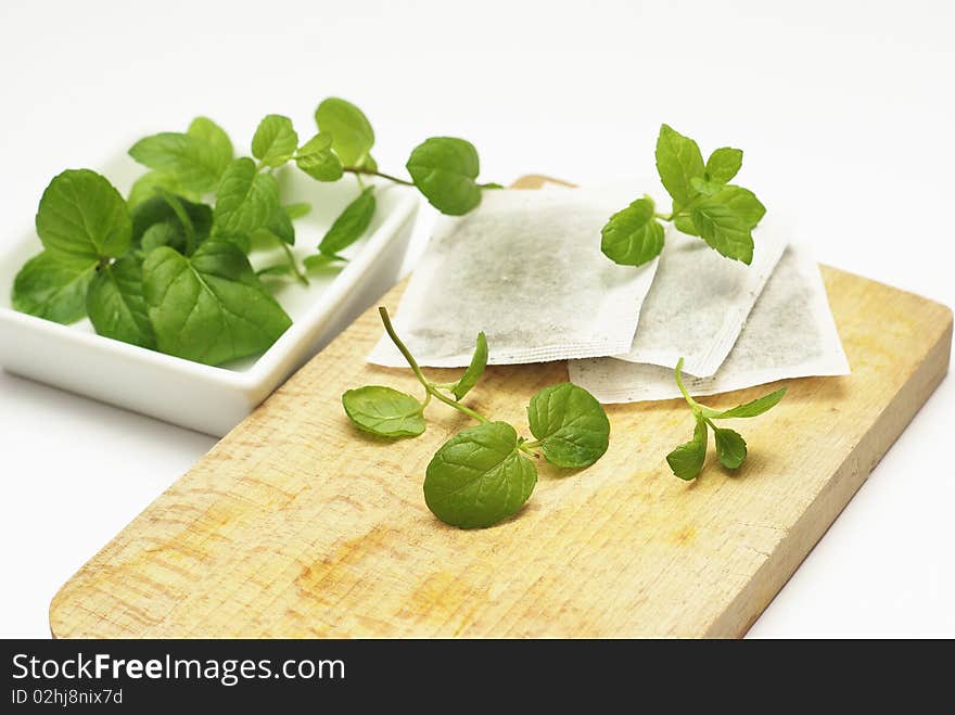 Mint tea bags and fresh mint leaves