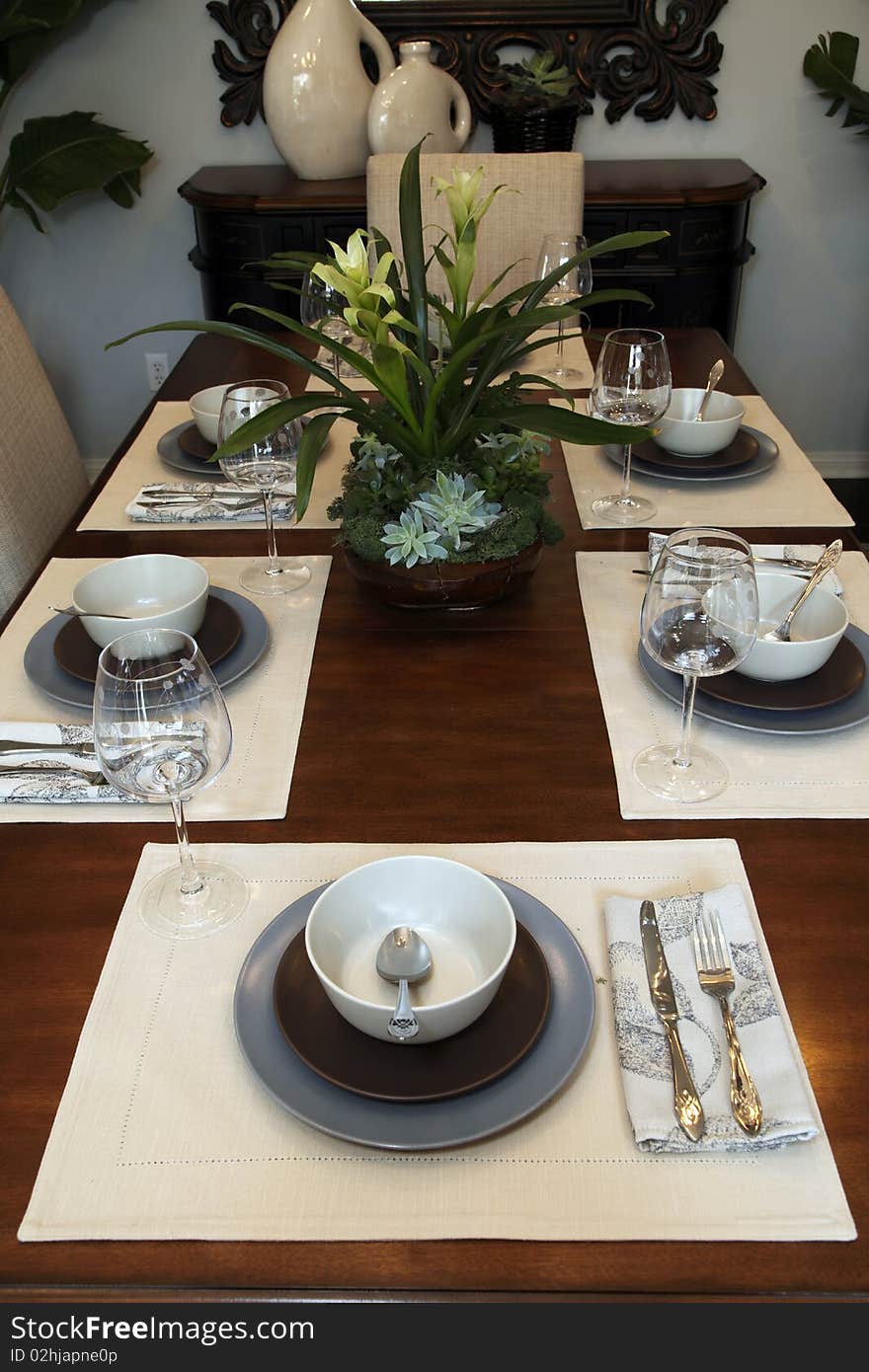 Dining table with contemporary tableware and festive decor. Dining table with contemporary tableware and festive decor.