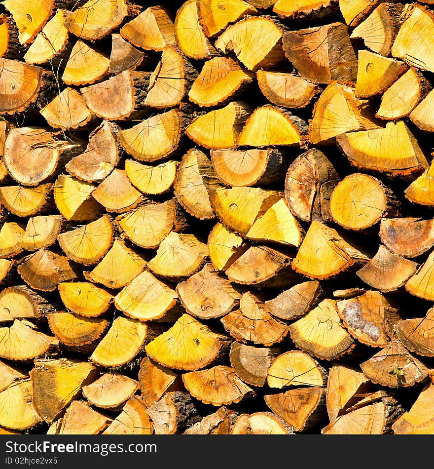 Big pile of firewood neatly aligned together