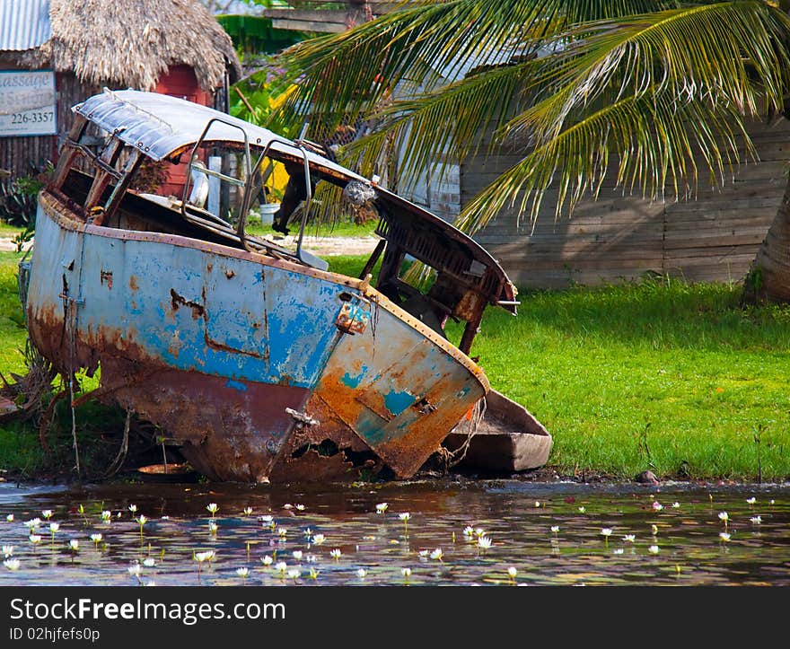 A small rusted, abandoned ferry in the town of Bomba, Belize. A small rusted, abandoned ferry in the town of Bomba, Belize