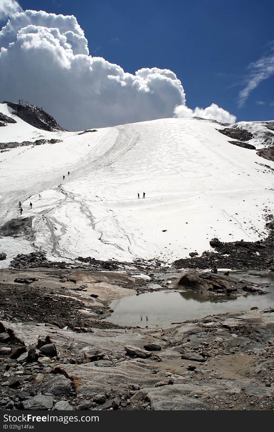 Tourists enjoying snow at 3000 meters altitude in august at Hintertux, Austria. Tourists enjoying snow at 3000 meters altitude in august at Hintertux, Austria