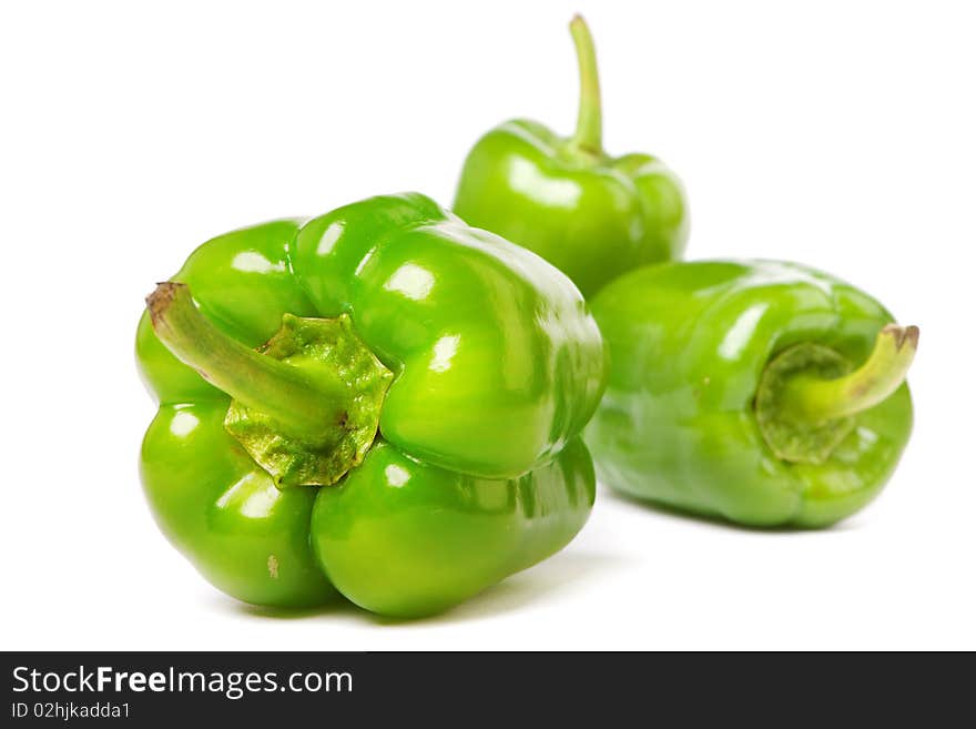 Green peppers on a white