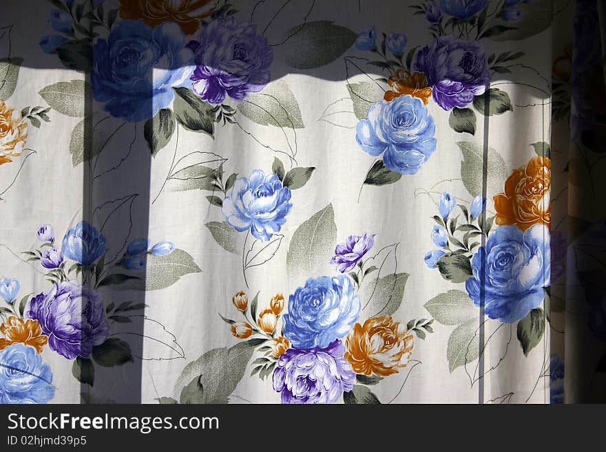 A color flower window curtain as background or texture. A color flower window curtain as background or texture.