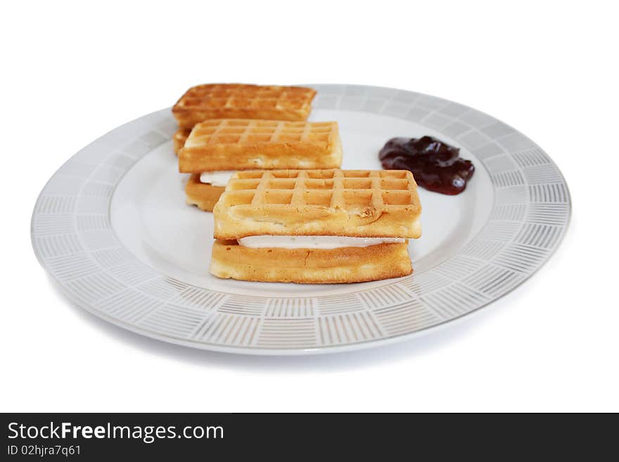 Isolated wafers with cherry jam on a plate. Isolated wafers with cherry jam on a plate