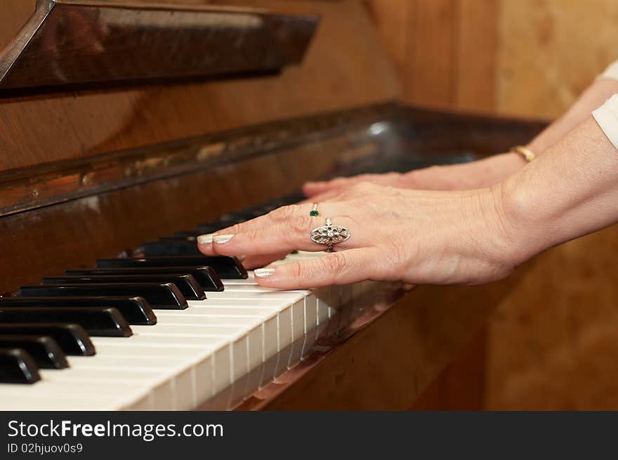 A caucasian woman s hand playing piano