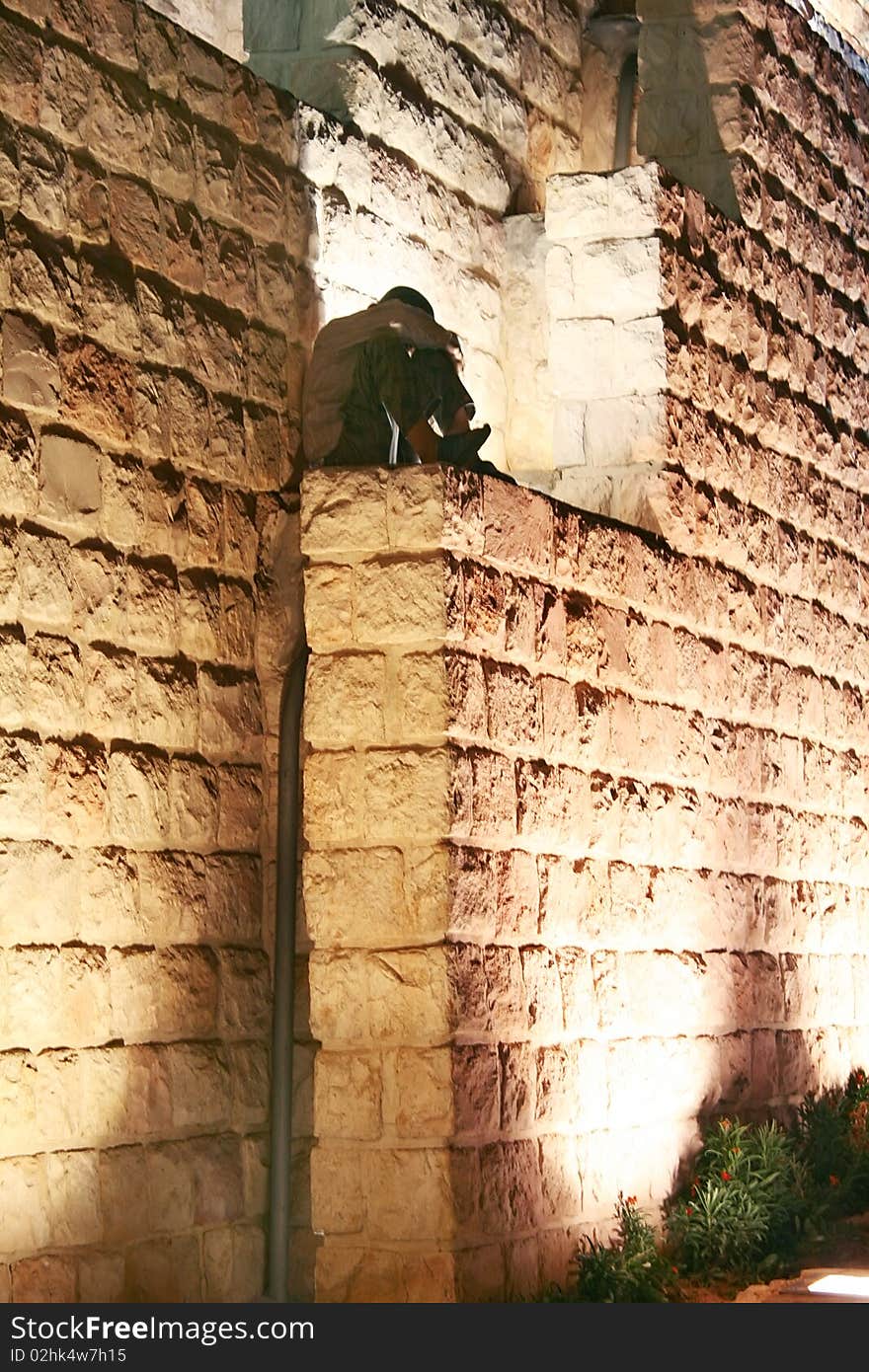 Lonely boy sitting on the wall steps