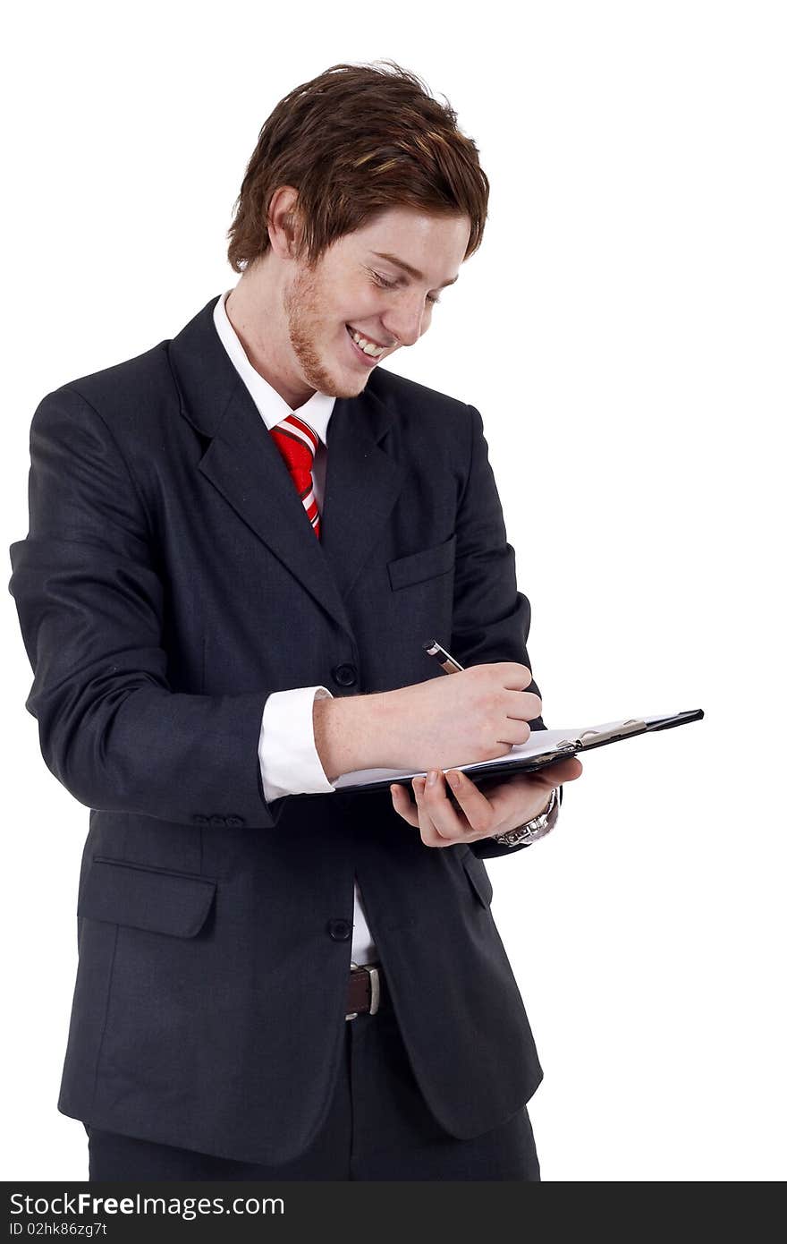 Handsome Businessman in black outfit shot in studio isolated on white - writing on clipboard. Handsome Businessman in black outfit shot in studio isolated on white - writing on clipboard