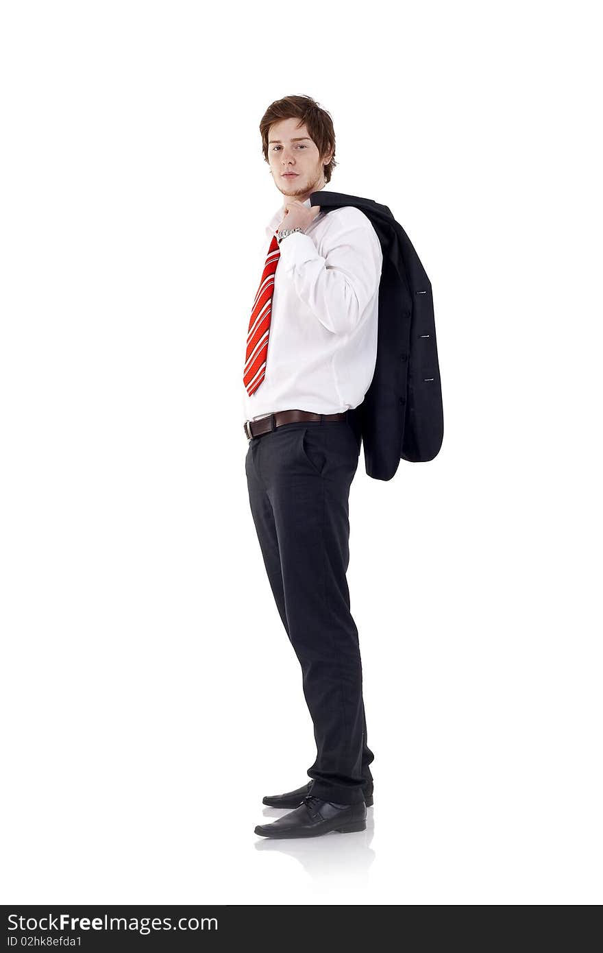 Full length profile of a young business man with coat over shoulder against white