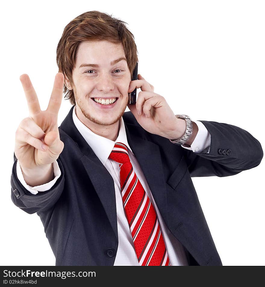 Picture of a businessman making victory sign while talking on the phone