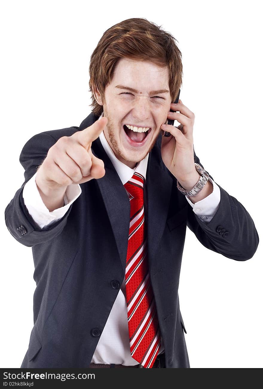 A handsome businessman pointing with finger while talking on the phone. All on white background.