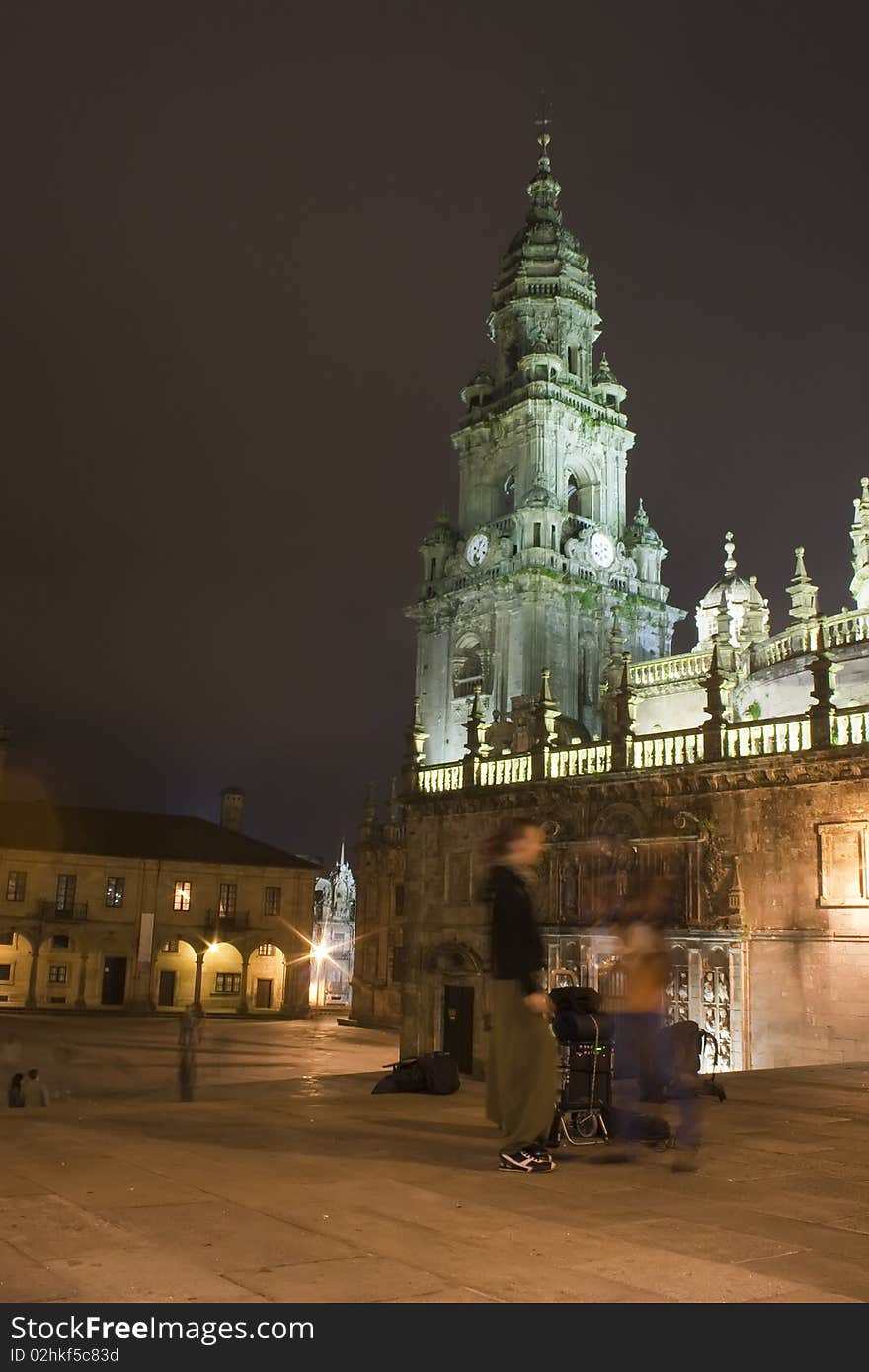 Tourist near Santiago cathedral. Quintana Square. Photo shot at night. Tourist near Santiago cathedral. Quintana Square. Photo shot at night