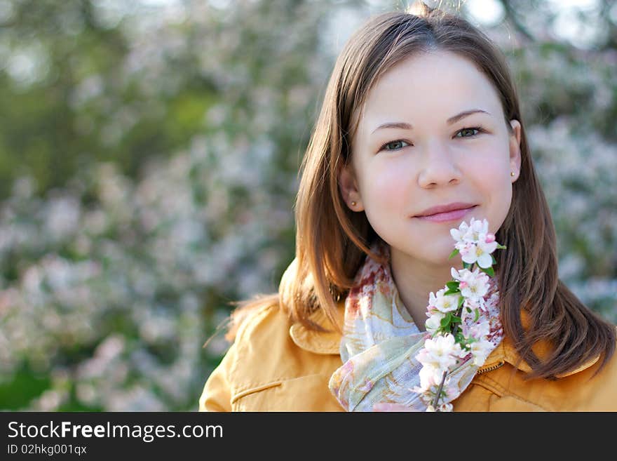 Young woman in blooming park