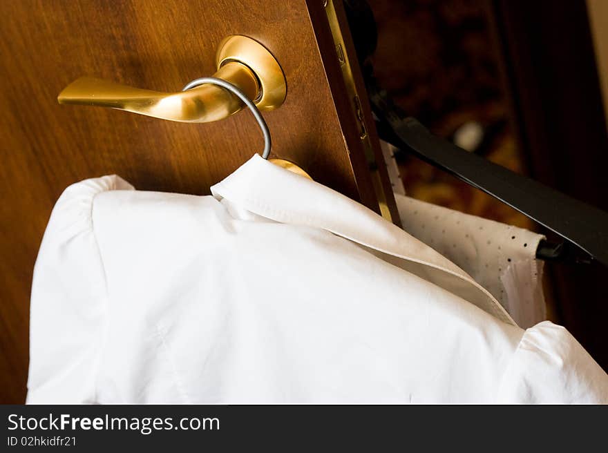 Female blouse on a hanger in room