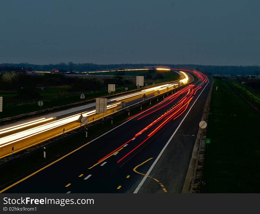 Traffic on a highway making curved light shape. Traffic on a highway making curved light shape