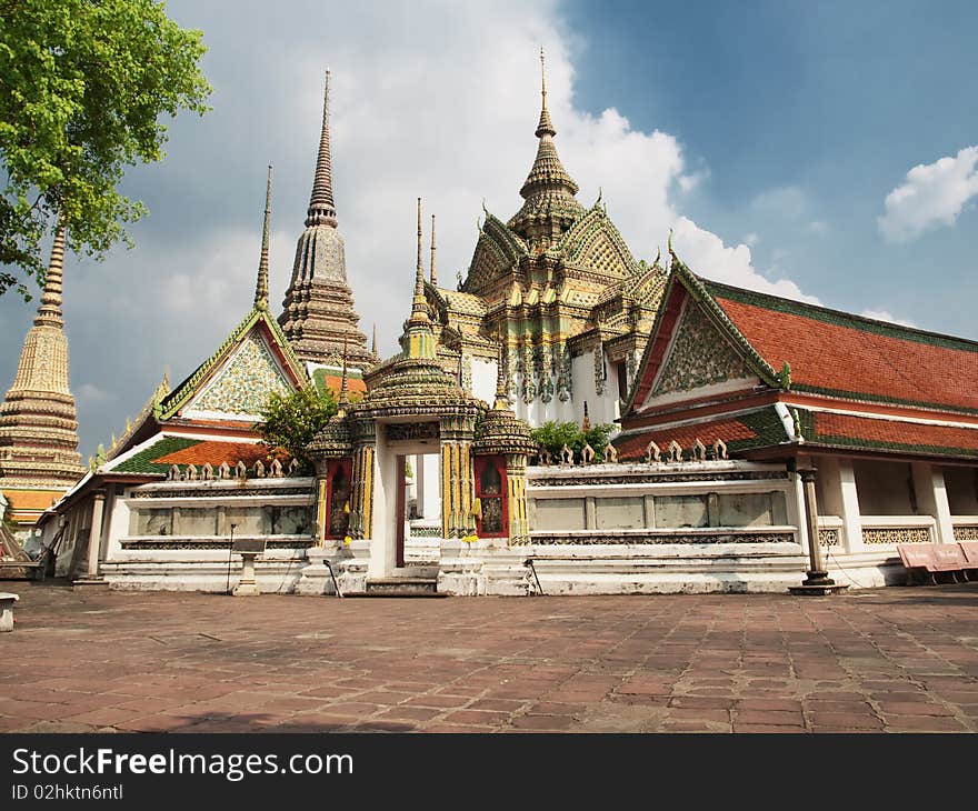 Buddhist temple Wat Pho on partly cloudy day, HDR image, Bangkok,Thailand