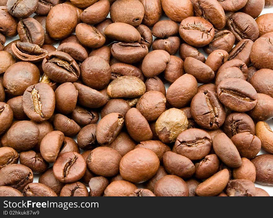 Roasted brown and aromatic coffee grain on whole frame close-up