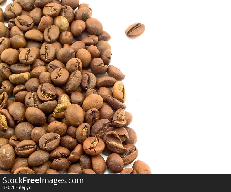 Roasted brown aromatic coffee grain is sprinkled on white background. Roasted brown aromatic coffee grain is sprinkled on white background