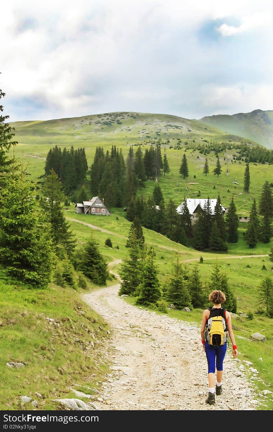 Woman hiker going towards meteorology  station in Tarcu  mountains, Romania. Woman hiker going towards meteorology  station in Tarcu  mountains, Romania