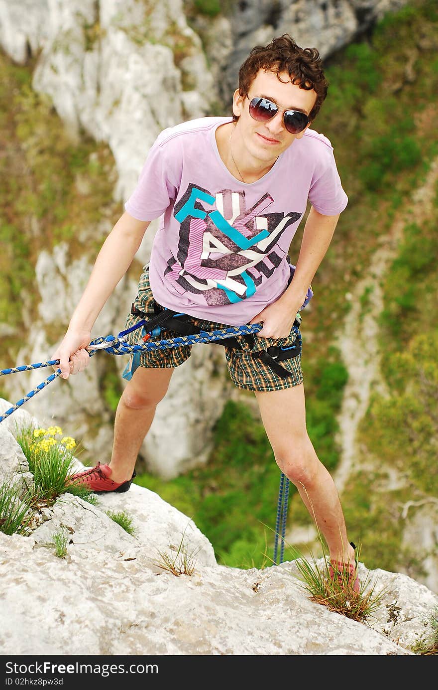 Climber preparing for rappel after finishing the climb. Climber preparing for rappel after finishing the climb