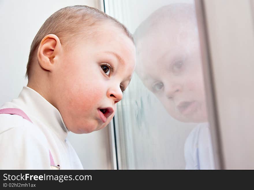 Young baby boy and mirror