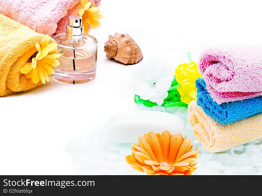 Spa towels with flower and bottle of perfume