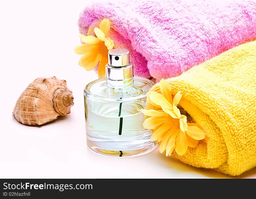 Spa towels with flower and bottle of perfume