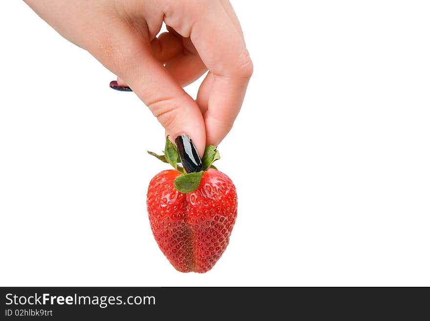 Strawberry in a female hand, it is isolated on a white background