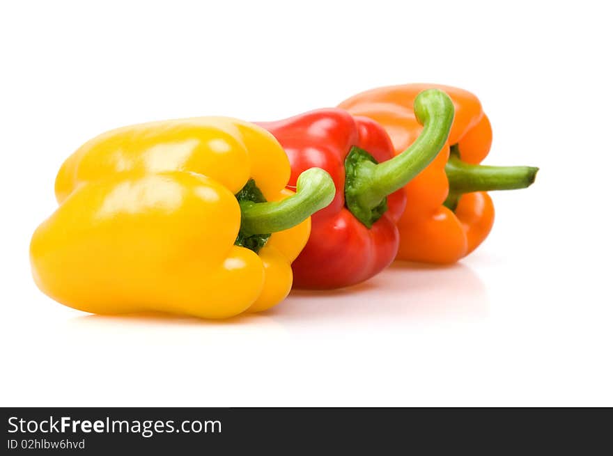 Red, yellow and orange bell peppers isolated on white. Red, yellow and orange bell peppers isolated on white.