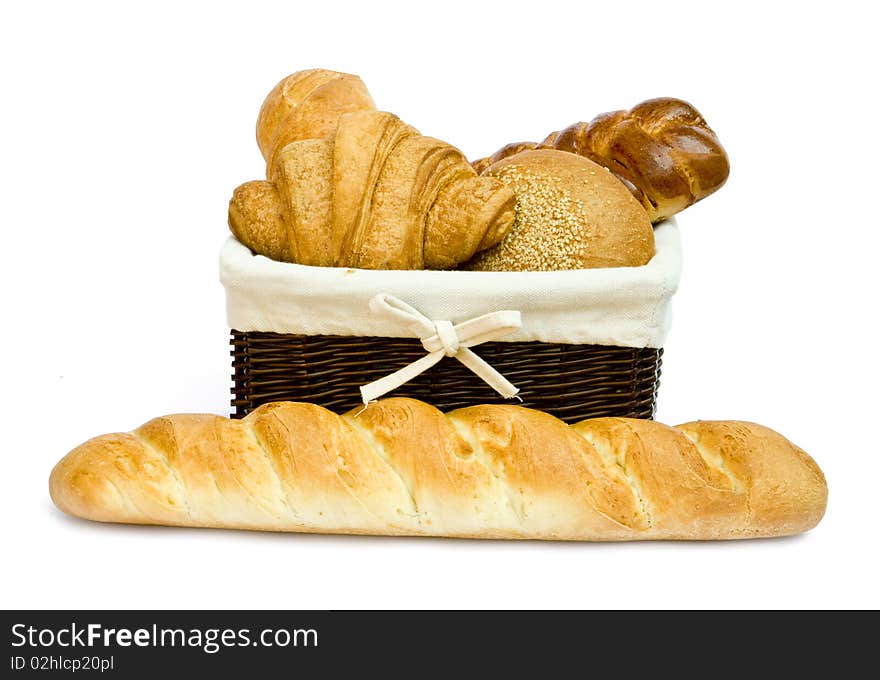 Fresh bread rolls in a basket on whitete