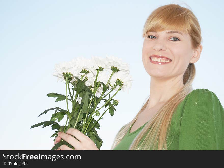 The young woman with a bouquet of colors on a background of the sky