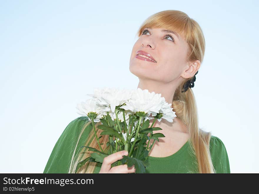 The young woman with a bouquet of colors on a background of the sky