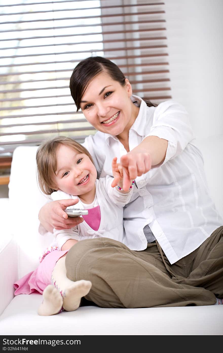 Mother and daughter having fun on sofa. Mother and daughter having fun on sofa