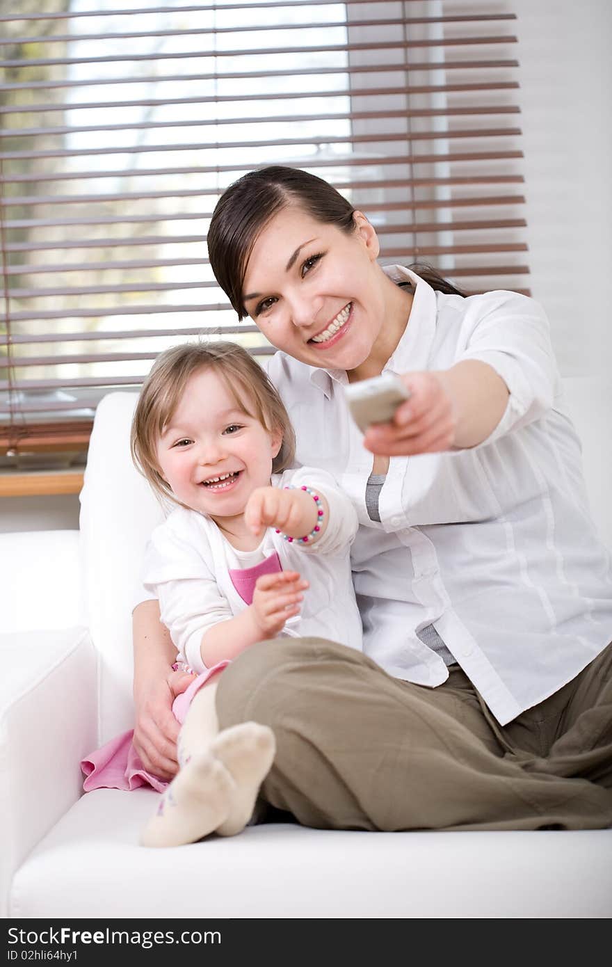 Mother and daughter having fun on sofa. Mother and daughter having fun on sofa