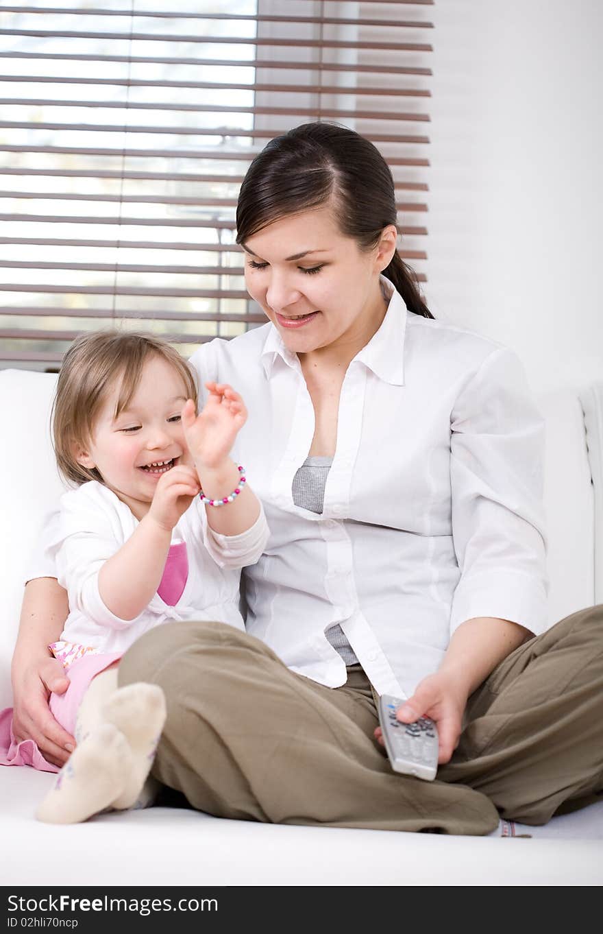 Mother and daughter having fun on sofa. Mother and daughter having fun on sofa