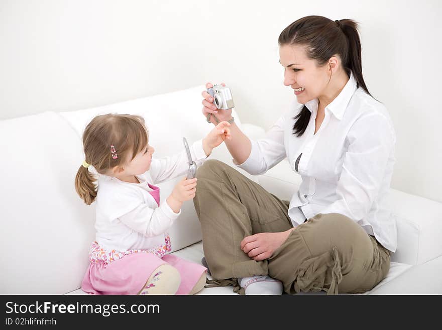 Mother and daughter having fun on sofa. Mother and daughter having fun on sofa