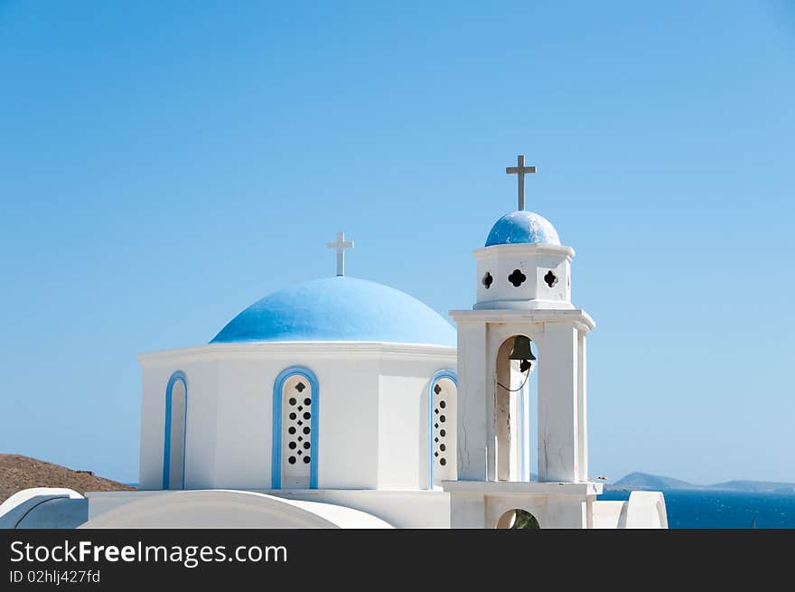 Greek church in santorini greece with a cross