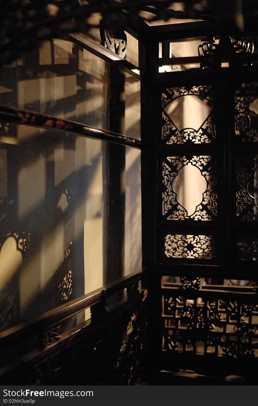 A traditional Chinese wood bed with delicate woodcarving. (taken in Wuzhen, a famous riverside town in South China). A traditional Chinese wood bed with delicate woodcarving. (taken in Wuzhen, a famous riverside town in South China)