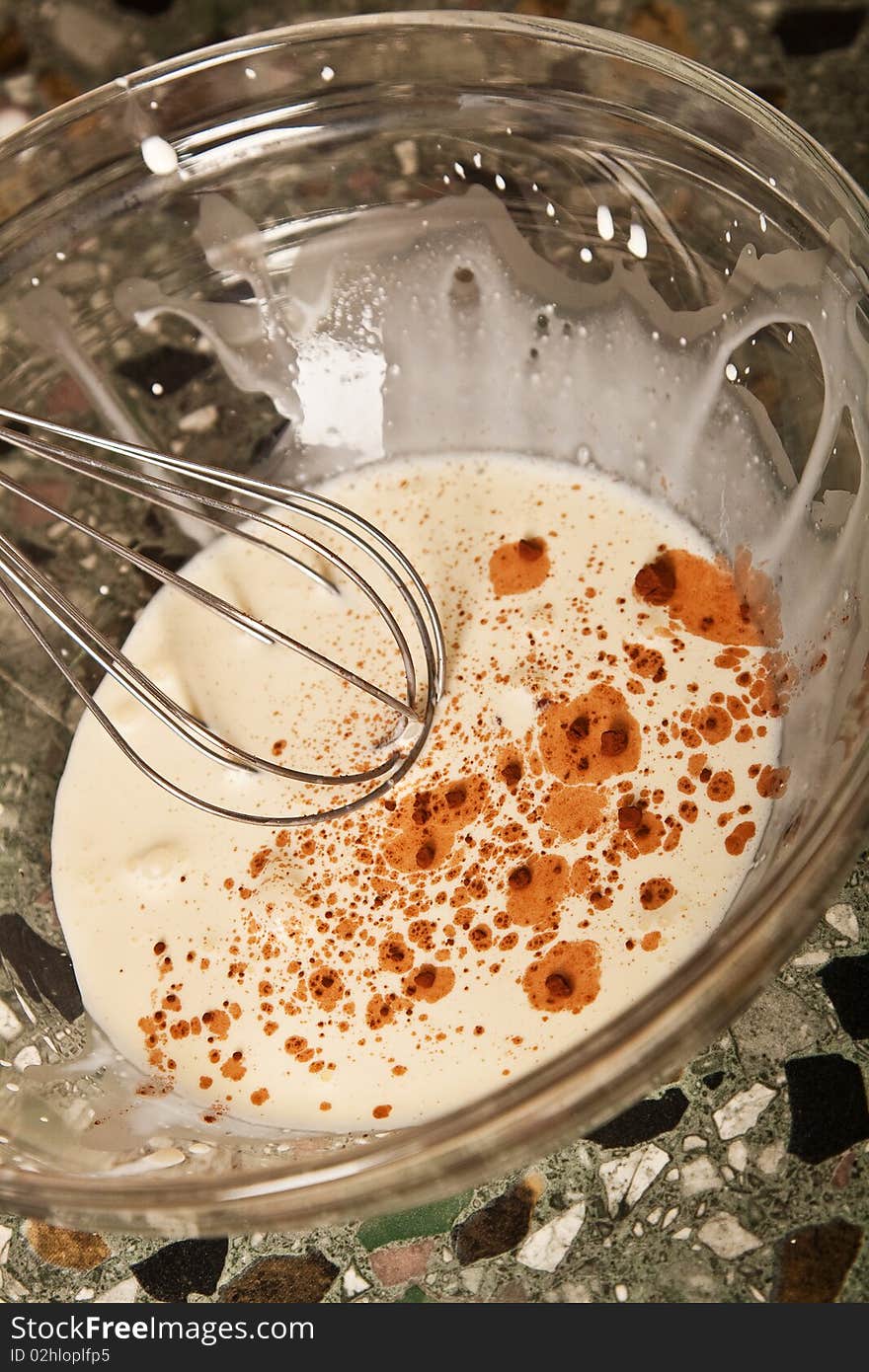 Whipping cream, whisk in a glass dish