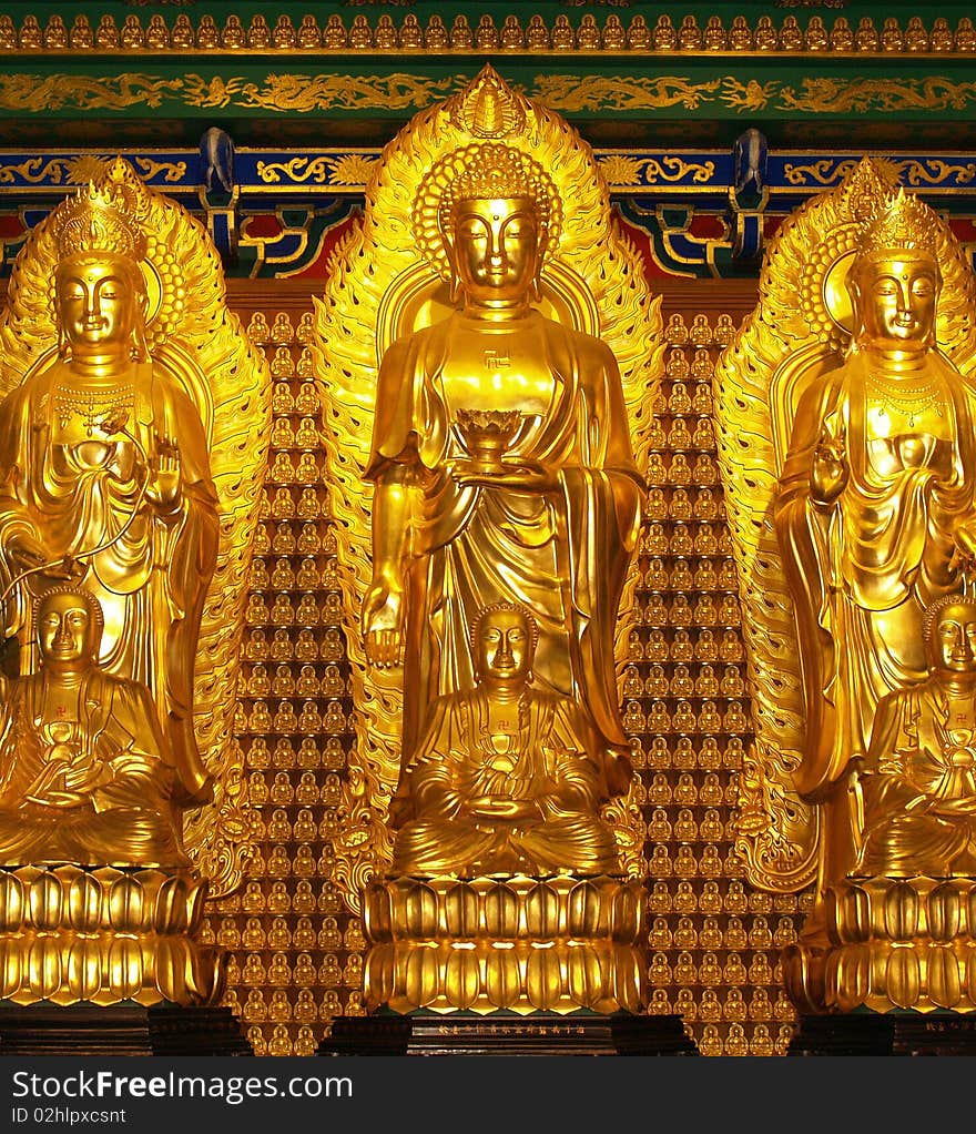 A lot of gold buddha statue stick on the wall