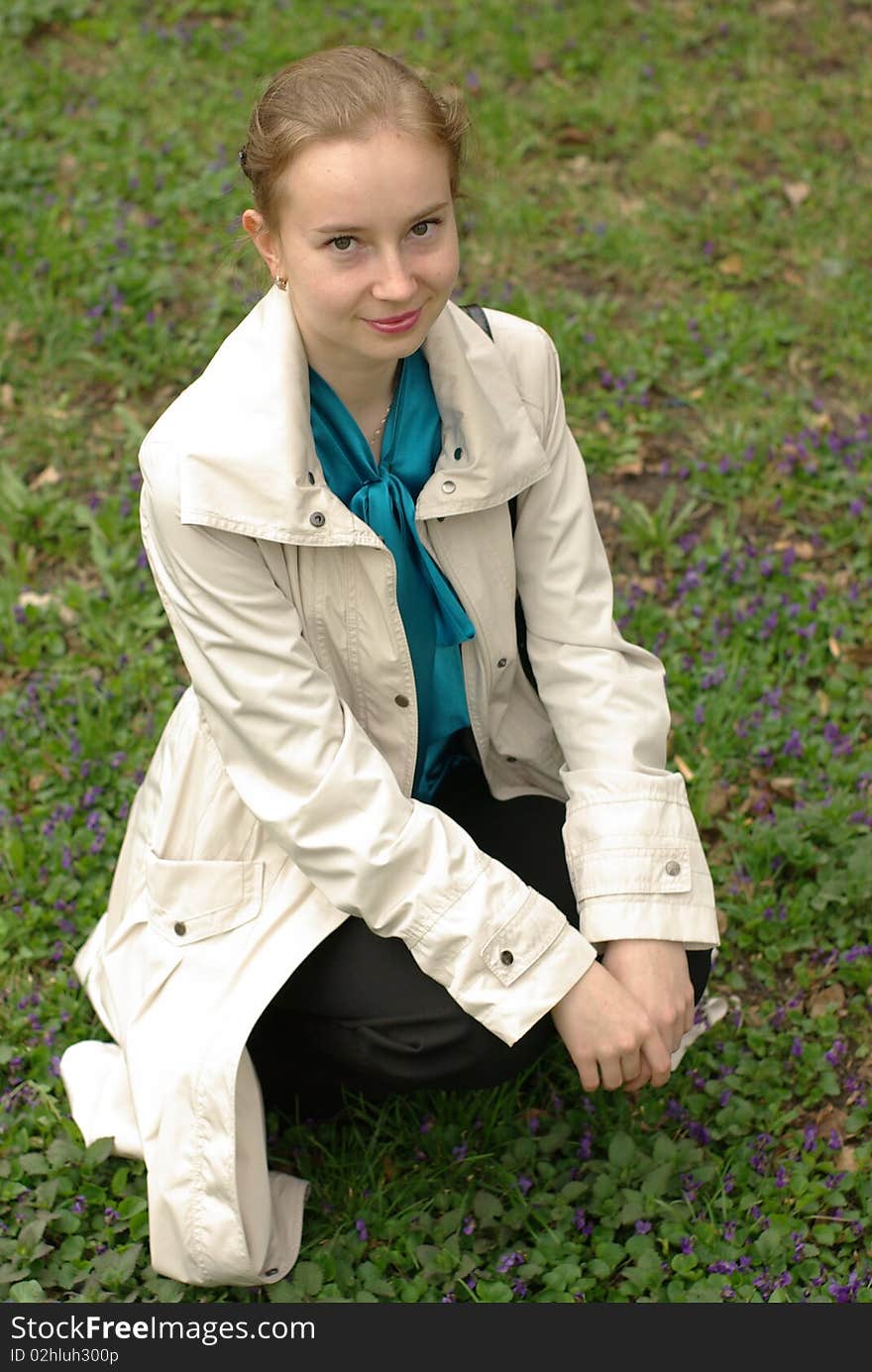 A girl sitting on the field