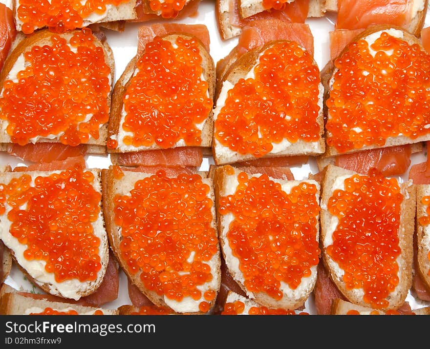 Sandwiches with red roe and salman isolated on white