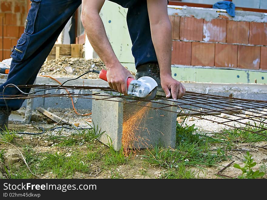 Man working with handtool on construction site. Man working with handtool on construction site