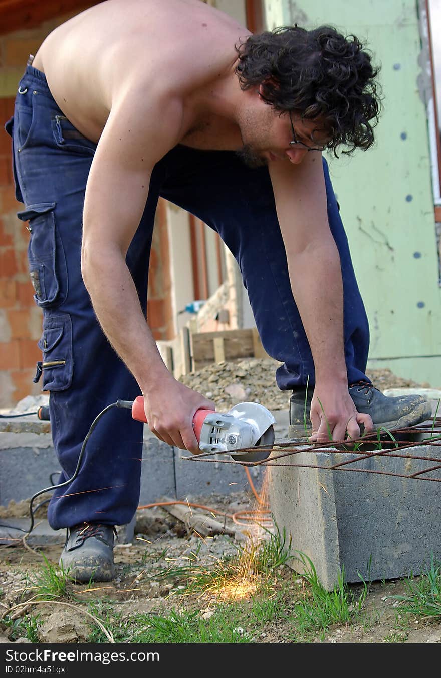 Man working with handtool on construction site. Man working with handtool on construction site