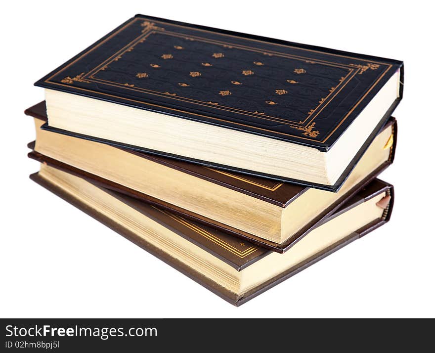 Stack of three vintage-style hardcover books, isolated on a white background. Stack of three vintage-style hardcover books, isolated on a white background.