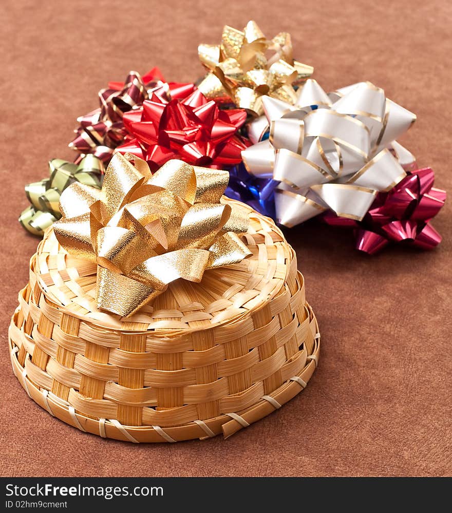 Gold Bow on Top of Wicker Basket. Gold Bow on Top of Wicker Basket