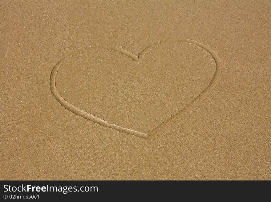 Heart drawn on sand on the seashore. Heart drawn on sand on the seashore