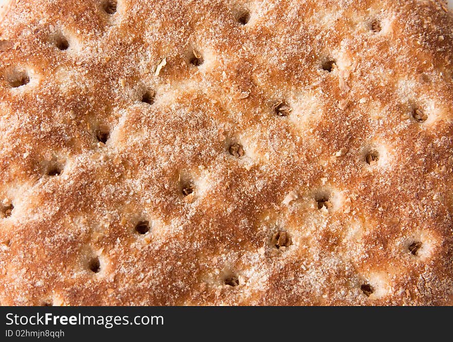 Closeup detail of top of bread bun with holes in diagonal pattern. Closeup detail of top of bread bun with holes in diagonal pattern