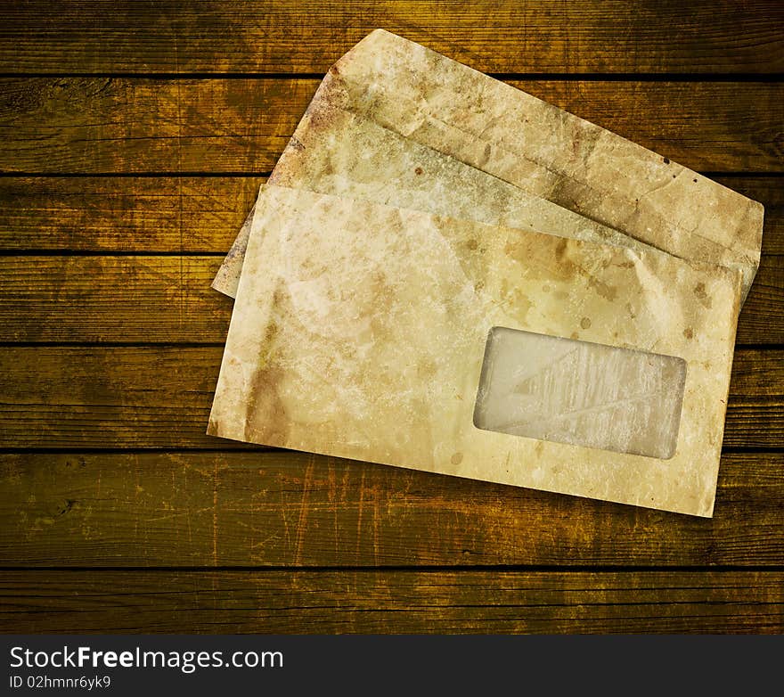 Old envelopes with some spots on a wooden background