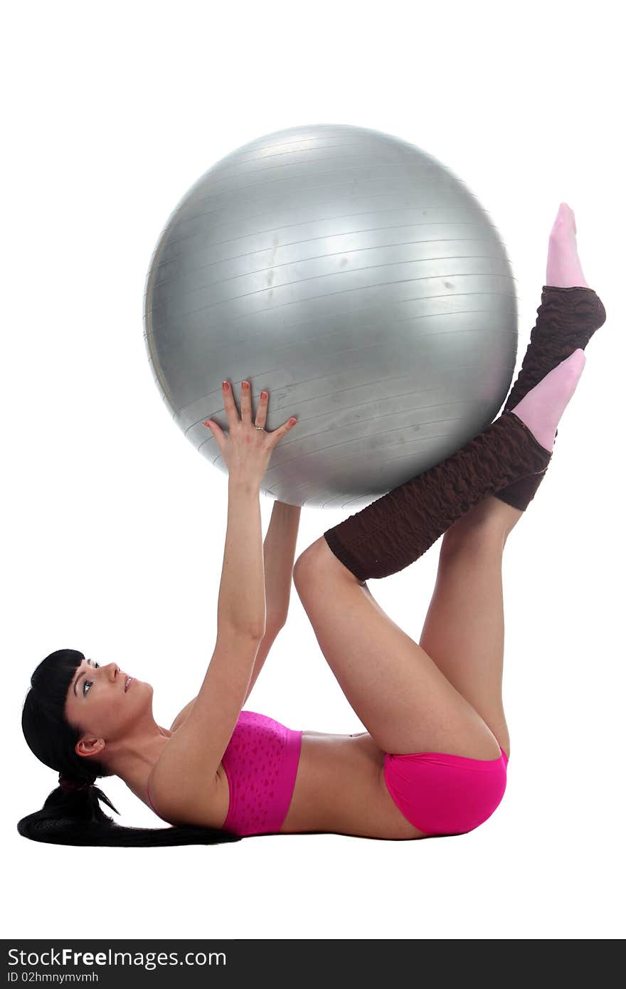 Attractive brunete girl doing gymnastic excersises with a ball. Attractive brunete girl doing gymnastic excersises with a ball