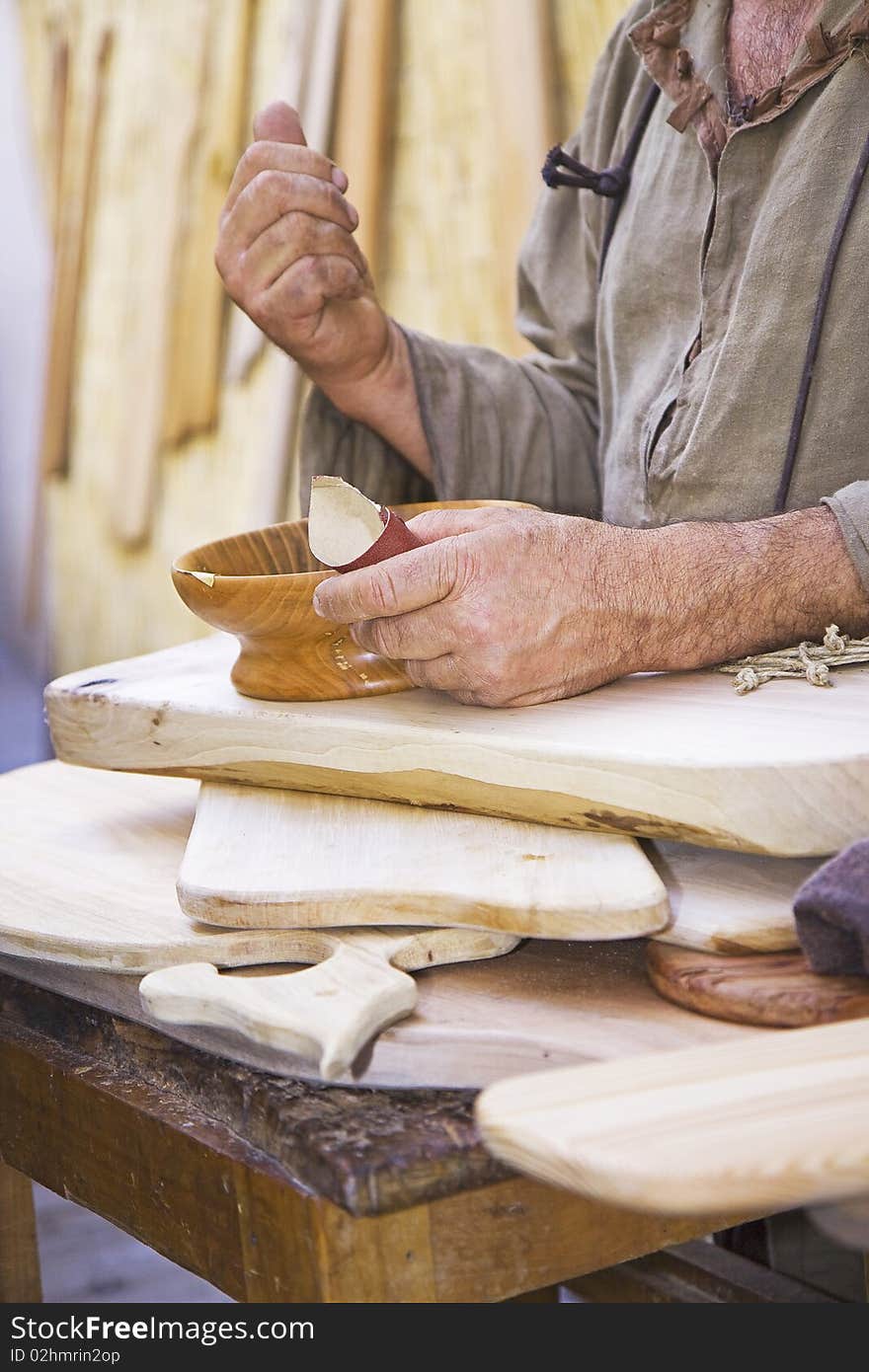 Craftsman works a wooden bowl. Craftsman works a wooden bowl